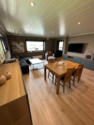 a living room with a wooden table and a couch at Lom Apartment in Lom