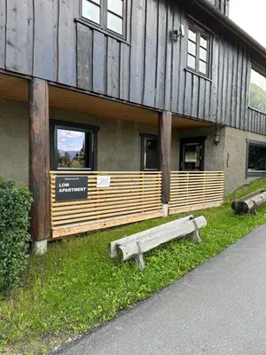 a building with a bench in front of it at Lom Apartment in Lom