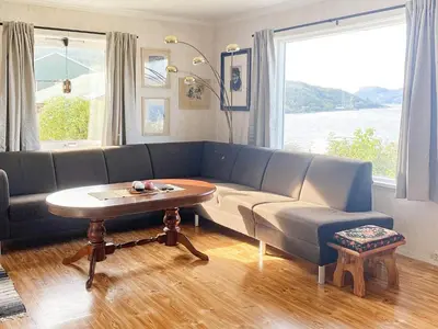 a living room with a blue couch and a table at 10 person holiday home in Brekke in Brekke