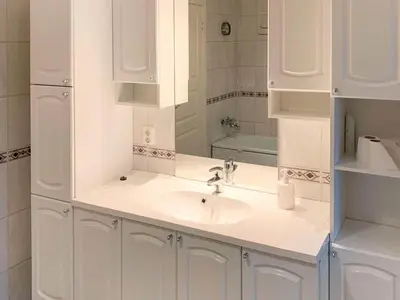 a white bathroom with a sink and a mirror at 10 person holiday home in Brekke in Brekke