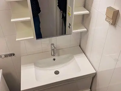 a white sink in a bathroom with a mirror at 6 person holiday home in Brekke in Brekke