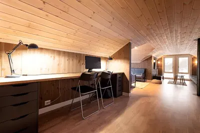 a room with a desk and chairs in a house at Lykkeli in Stranda