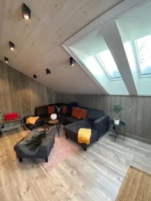 a living room with a couch and a table at Villa Solsiden Geilo in Geilo