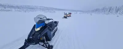 a group of people on a snowmobile in the snow at Villa Fregn in Ljørdal