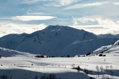 a snow covered mountain in front of a snow covered field at Flotunet - Anestova in Stryn