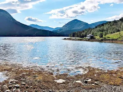 a body of water with mountains in the background at 8 person holiday home in Austefjorden in Austefjorden