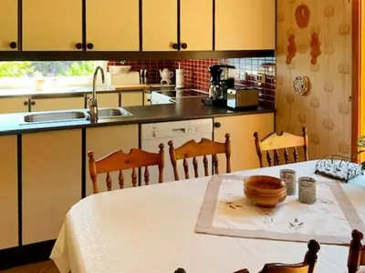 a kitchen with a table and a sink and a counter top at 8 person holiday home in Austefjorden in Austefjorden