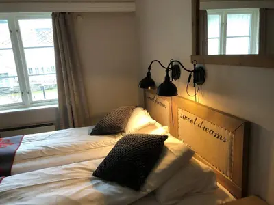 a bedroom with two beds and a window at Dale-Gudbrands Gard by Frich`s in Sør-Fron