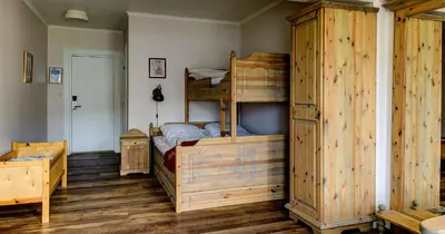 a bedroom with two bunk beds and a wooden cabinet at Dale-Gudbrands Gard by Frich`s in Sør-Fron