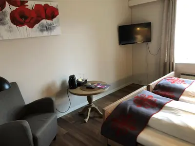 a room with a bed and a table and a chair at Dale-Gudbrands Gard by Frich`s in Sør-Fron
