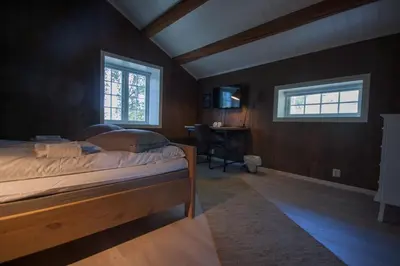 a bedroom with a bed and a desk and a window at Dale-Gudbrands Gard by Frich`s in Sør-Fron