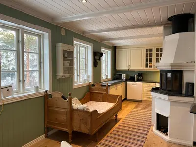 a kitchen with a bed in the middle of a room at Stille og fredelig med panoramautsikt in Valsøybotn