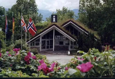a building with two flags in front of it at Hardanger Feriesenter Sjusete in Norheimsund