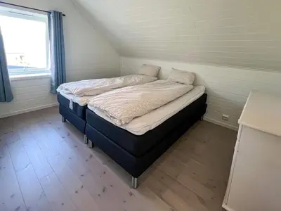 a small bedroom with a bed in a room at 8 person holiday home in Svelgen in Svelgen