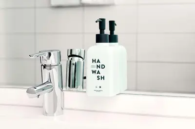 a bottle of shampoo next to a bathroom sink at Scandic Ørnen in Bergen