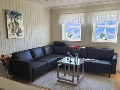 a living room with a couch and a table at Flohytta in Stryn