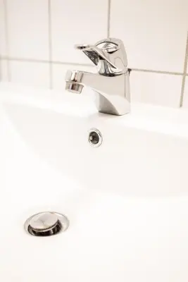 a bathroom sink with a faucet at Oppdal Gjestetun Hotell in Oppdal