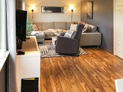 a living room with a couch and a tv at 6 person holiday home in AVERØY in Stein