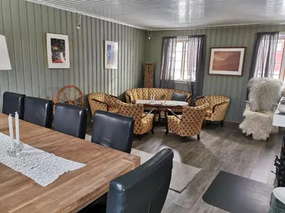 a dining room with a table and chairs at Yttervik gard in Steinkjer
