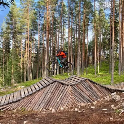 a person on a bike jumping over a wooden bridge at In the middle of Trysilfjellet - Welcome Center - Apartment with 3 bedrooms - By bike arena and ski lift in Trysil