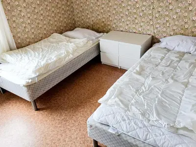 two beds sitting next to each other in a bedroom at 9 person holiday home in KORTGARDEN in Skalle