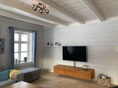a living room with a flat screen tv on a wall at Comfortable house in quiet area in Luster