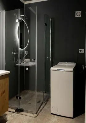 a bathroom with a shower and a toilet and a sink at Vollsnes Gjestehus in Stryn