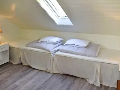 a bed in a room with two pillows on it at 10 person holiday home in Stordal in Stordal