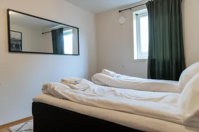a room with a mirror on the wall at Stryn Apartments - City Center - Modern Suites in Stryn