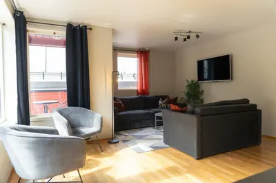 a living room with a couch and two chairs at Stryn Apartments - City Center - Modern Suites in Stryn