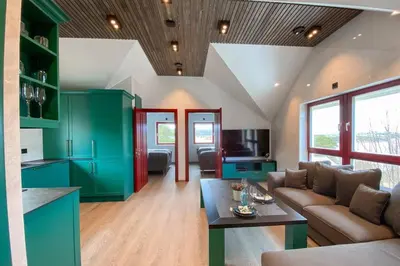 a living room with a couch and a table at Flatanger Turkish Bath apartment in Lauvsnes