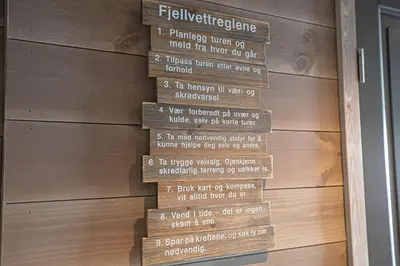 a sign on the side of a building with a door at Panorama 13 - beautiful view! in Sogndal