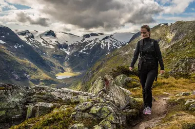 a woman walking on a trail in the mountains at Hodlekve Panorama 5 - amazing view in Sogndal