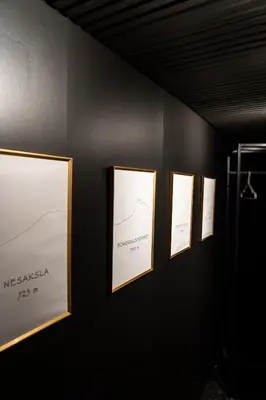 a row of framed pictures on a wall at ÅNDALSNES UNDERGROUND flat in Åndalsnes