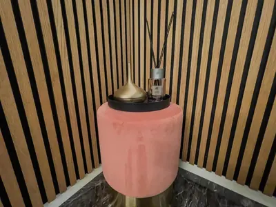 a pink vase with a gold top on a table at ÅNDALSNES UNDERGROUND flat in Åndalsnes
