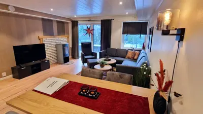 a living room with a couch and a table at Otnes Fjordside - Large 80m2 860sqft in Aurland