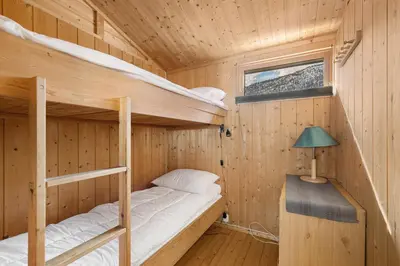 a wooden cabin with two bunk beds in it at Lem Cabins in Sogndal