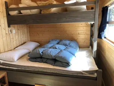 a bunk bed in a room with pillows on it at Skarehaug - koselig hytte med 3 soverom in Eggedal