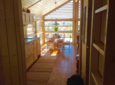 a kitchen with a table and a dining room at Skarehaug - koselig hytte med 3 soverom in Eggedal