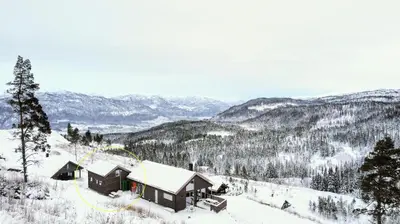a ski lodge in the snow on a mountain at Tiny mountain cabin with a panoramic view in Giljane