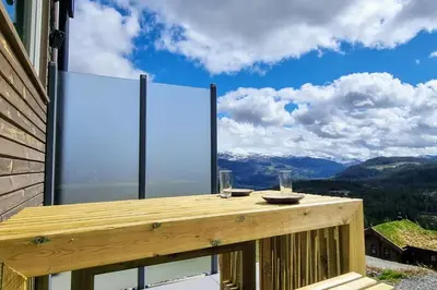 a balcony with a view of the mountains at Tiny mountain cabin with a panoramic view in Giljane