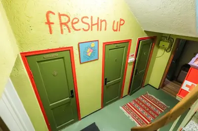 a room with three green doors and a sign that reads fresh up at Tiglkåk in Åndalsnes