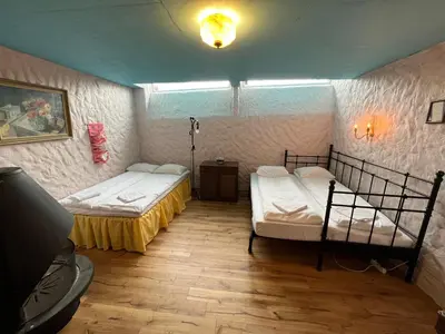 a room with two beds in a room at Tiglkåk in Åndalsnes