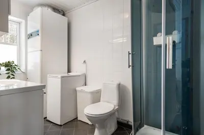 a bathroom with a toilet and a glass shower at Cabin in Trysil with seaview to lake in Trysil