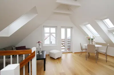 a living room with a table and chairs at Villa Skansen in Bergen