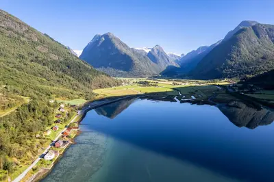 an aerial view of a lake with mountains in the background at Cabin alongside the beautiful fjærlandsfjord in Fjarland