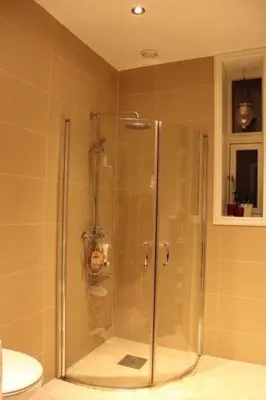 a shower with a glass door in a bathroom at City Center Apartment in Ålesund