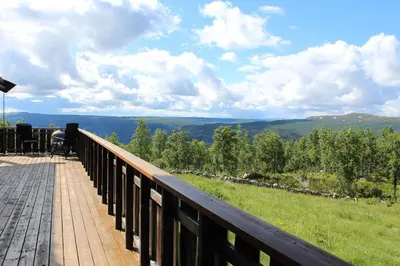 a wooden deck with a view of the mountains at Storemyr by Norgesbooking - cabin with amazing view in Hol
