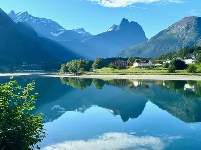a view of a lake with mountains in the background at Åndalsnes Sentrum 1-room Apartment in Åndalsnes