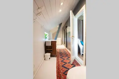 a hallway of a house with a sink and a rug at Eika Cottage: Cozy, rural, spacious and well-equiped in Åmot